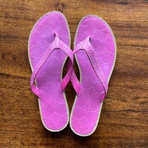 Pink COACH initial leather flip flop.
